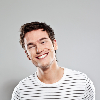 young man with a straight white smile from braces and orthodontics services