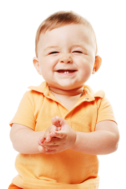 A smiling baby with his first two bottom teeth showing