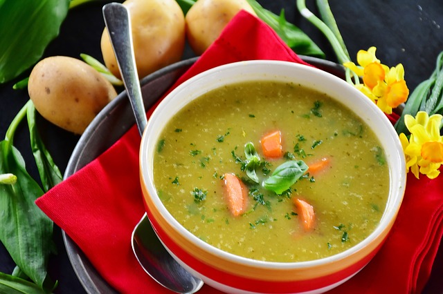 A photo of creamy potato soup with assorted vegetables